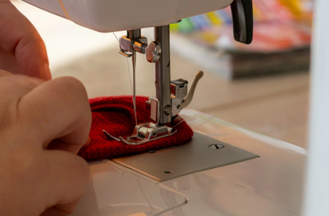 Sewing a red sweater
